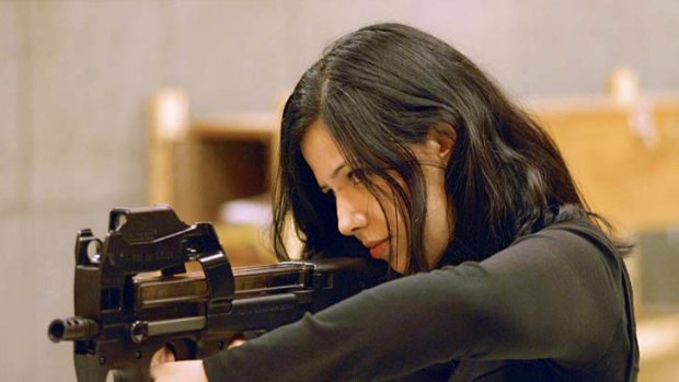 Jalila Essaidi pointing a gun at a target at an undisclosed location.