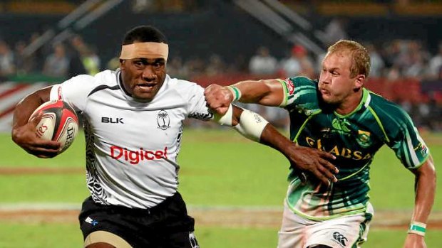Leo Naikasau of Fiji escapes a tackle by Philip Snyman of South Africa in the final.