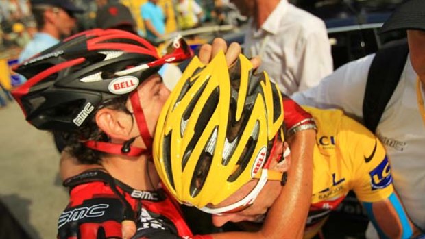 Emotional . . .  Cadel Evans collapses in tears into the arms of teammate Mauro Santambrogio who helped the former race leader over the final section of stage nine.