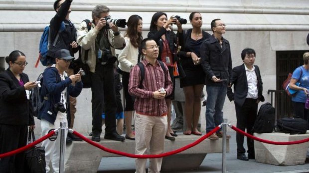 Media and Chinese tourists look out for Jack Ma outside the New York Stock Exchange on Friday.