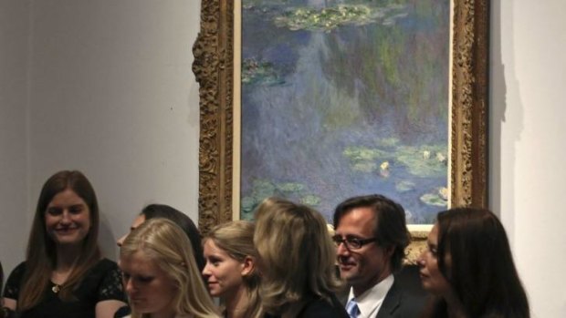 Christie employees in front of Claude Monet's "Nympheas" during the New York auction on May 6, 2014.