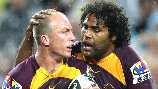 Darren Lockyer and Sam Thaiday of the Broncos celebrate a try.