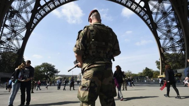 A paratrooper patrols under the Eiffel Tower: Islamic States on Muslims to kill citizens of countries taking part in the US-led coalition against the jihadists.