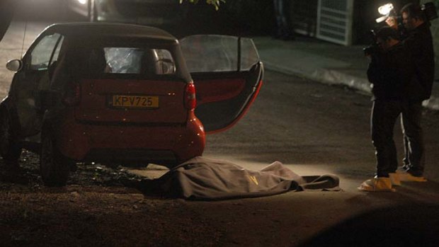 Gunned down outside his home: the body of Andis Hadjicostis lies on the street.