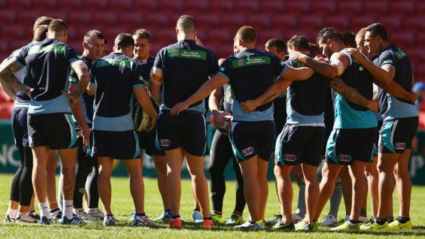 Behind enemy lines: The Blues huddle up on Suncorp Stadium, where they will tonight attempt to end seven years of Queensland Origin dominance.