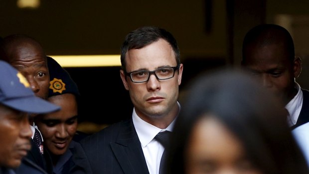 Paralympic track star Oscar Pistorius leaves after listening to the closing arguments in his murder trial at the high court in Pretoria in this August 7, 2014 photo.