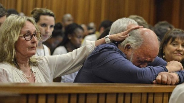 Barry Steenkamp, father of Reeva Steenkamp, is consoled by his wife June Steenkamp during the sentencing hearing.