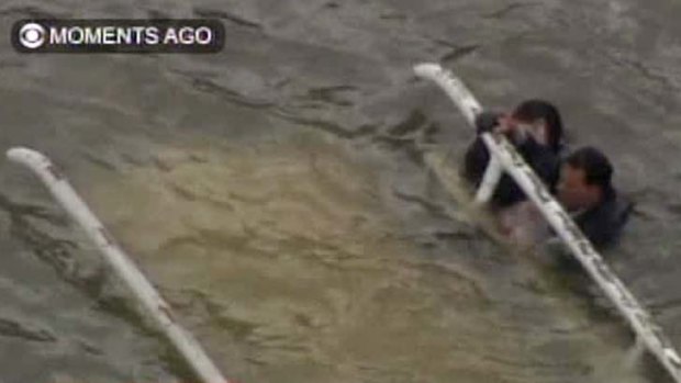 Crash ... in this frame grab image taken from WCBS-TV, survivors cling to the bottom of the helicopter.