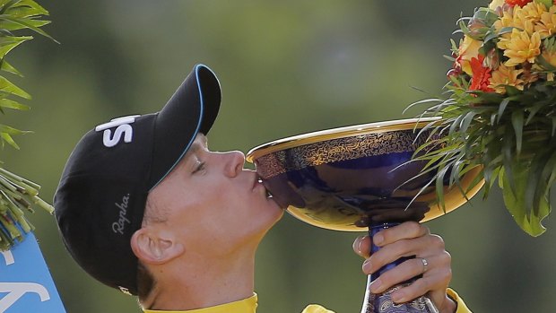 Tour de France winner Chris Froome kisses the trophy.