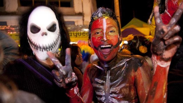 Lighten up... teenagers celebrate the Day of the Dead festival.