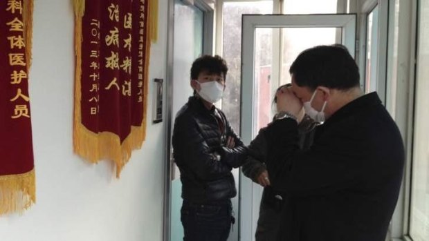 Friends of human rights activist Cao Shunli outside an intensive care unit earlier this month. They were not allowed to go inside the hospital unit.