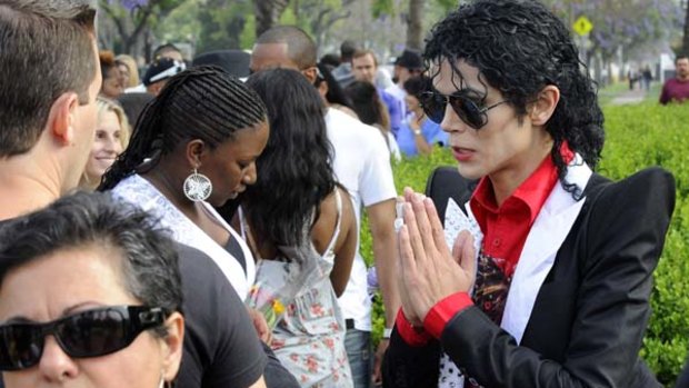 Michael Jackson impersonator Carlo Riley waits to pay tribute to the late pop star Michael Jackson at his grave at Forest Lawn Memorial Parks and Mortuaries in Glendale, California.