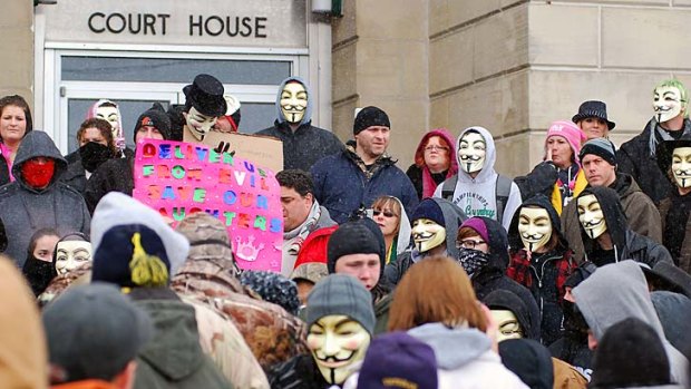 Outraged ... activists from the online group Anonymous rally outside court in Steubenville last month.