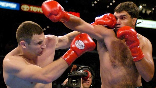 Trading blows with Vitali Klitschko in a 2004 WBC heavyweight championship bout ... Corrie Sanders, right , who died on Sunday.