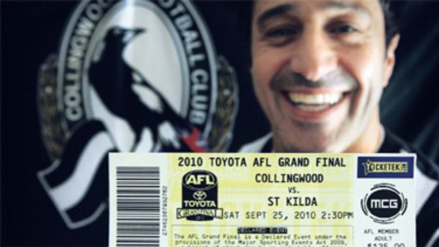 One of the lucky ones: Collingwood fan Frank Diaco has every reason to smile as he clutches his grand final ticket.