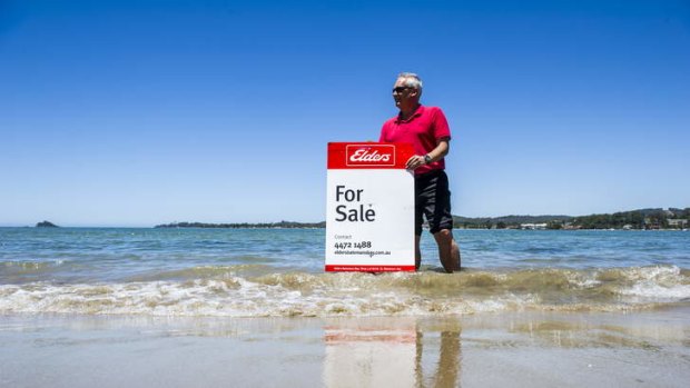 Elders Batemans Bay principal, Greig McFarlane, with a for sale sign at the small piece of land he is selling in Batemans Bay.