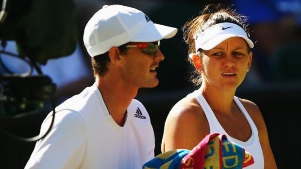 Jamie Murray of Great Britain and Casey Dellacqua discuss tactics during their third round match against Horia Tecau of Romania and Sania Mirza of India at Wimbledon.