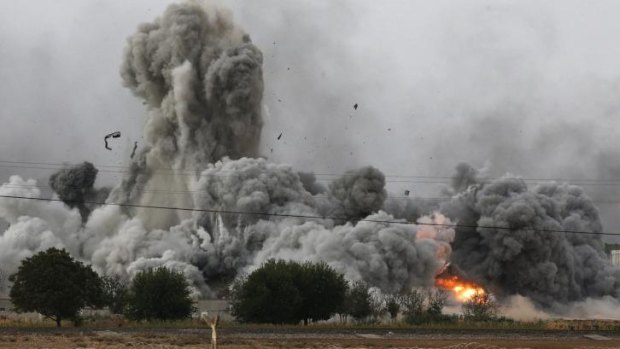 Smoke, debris and fire rise in Kobane after an air strike by the US-led coalition.