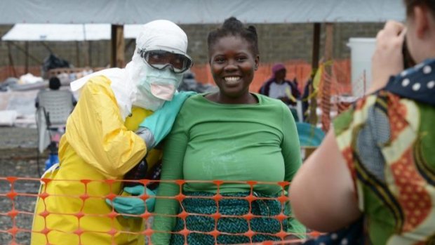 A health worker and a woman pose inside the high-risk area at Elwa hospital in Monrovia.