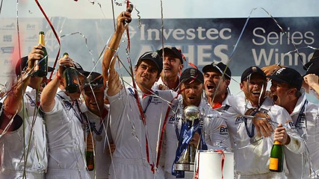 Well urned: Alastair Cook raises the iconic trophy after retaining the Ashes in August.