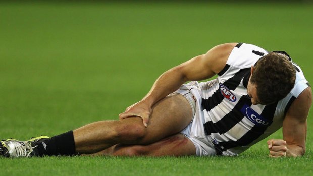 Luke Ball of the Magpies clutches his knee after injuring it the first time. He will miss the rest of the season.
