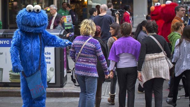 Times Square is filled with buskers dressed up as pop-culture characters, who make a living from tips charged to tourists who pose for photos with them.