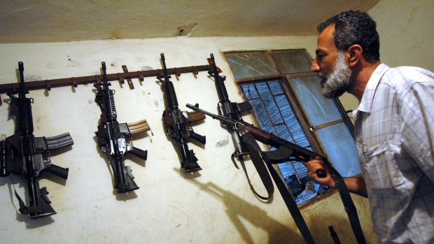 Fatah commander Munir al-Makdah with weapons at his home in Ain al-Hilweh.