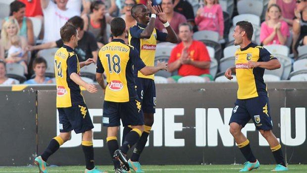 Bernie Ibini celebrates with his teammates after socring against the Perth Glory.