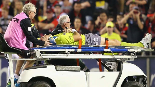 Umpire Troy Pannell is stretchered off after hitting heads with Nick Malceski.