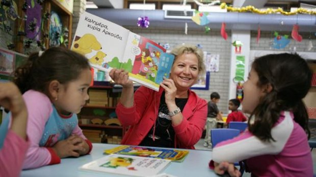 Spot the difference ... Greek teacher Sofia Patala reads to kids at the Greek Orthodox Community of NSW Childcare Centre.