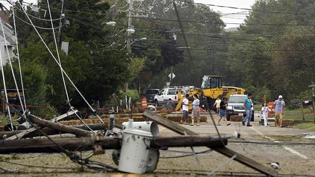 Residents inspect fallen power lines in Hampton Bays, New York.