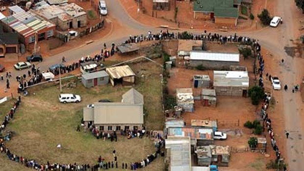 %Good  turnout . . . voters lining up in Johannesburg.