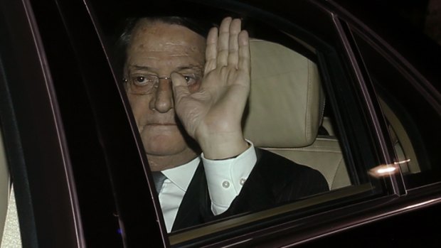 Deal struck ... Cyprus' President Nicos Anastasiades waves as he arrives at the presidential palace in Nicosia.