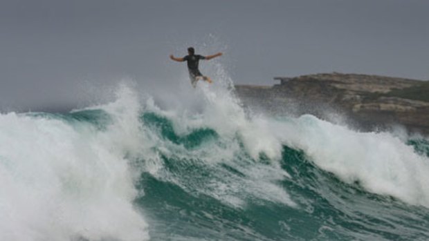 Bound for heaven ... a Maroubra surfer vacates a giant wave by executing a ‘‘flying angel’’.