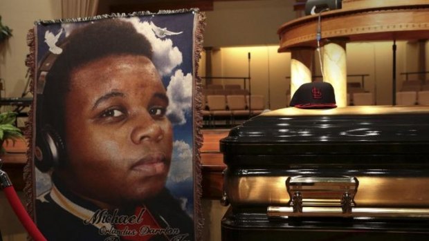 A baseball cap and a portrait of Michael Brown is shown alongside his casket inside Friendly Temple Missionary Baptist Church before the start of funeral services in St. Louis, Missouri.