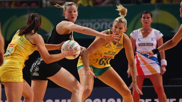 One-way traffic ... Catherine Cox primes herself to receive the ball yesterday from Madison Browne at Allphones Arena. The Silver Ferns could not overcome Australia's fast start.