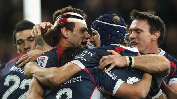 The Rebels celebrate during the match against the Crusaders.