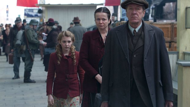From left: Sophie Nelisse, Emily Watson and Geoffrey Rush in <i>The Book Thief</i>.