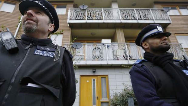 "Trapped by monster": police stand guard at the flat in Brixton.