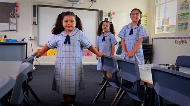 All new: (from left) Anhaar Kareem, 6, with sister Salma, 4, and Julia Gomez, 8, are among the 87 students who comprise the first intake at the Marie Bashir Public School.