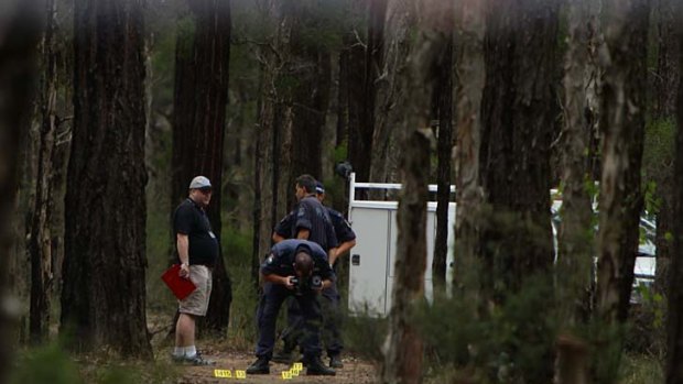 Grim task ... police investigating the death of Kiesha Abrahams search the site where remains were found yesterday.