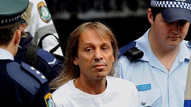 Alain Robert looks wistful after another adventure ends the same way ... in handcuffs.