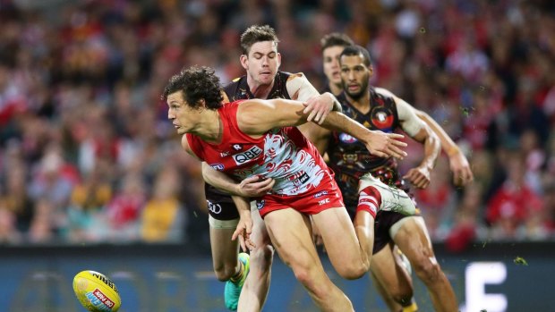 Reined in: Kurt Tippett is tackled during Hawthorn's last minute win over the Swans, who almost staged a comeback at the SCG.