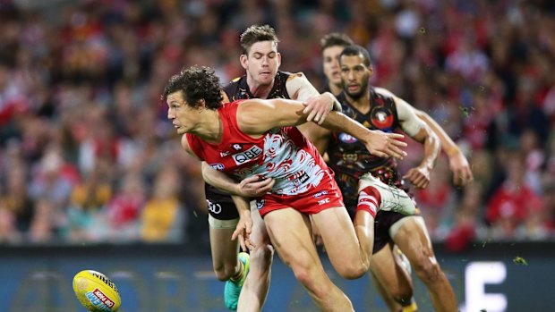 Reined in: Kurt Tippett is tackled during Hawthorn's last minute win over the Swans, who almost staged a comeback at the SCG.