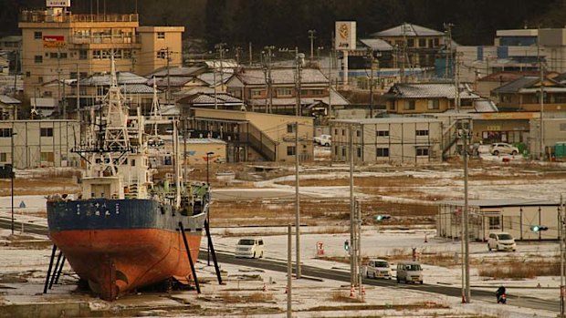 Permanent reminder: a fishing boat washed ashore by the tsunami sits in a deserted port area in Kesennuma, Miyagi prefecture, northeastern Japan, at dawn on Monday 11 March, 2013.