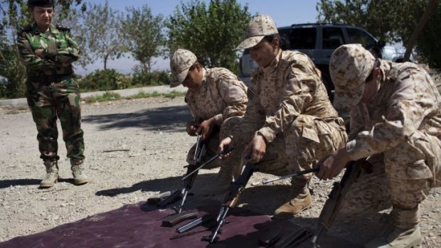 Weapons drill: Female Peshmerga recruits assemble AK-47 rifles during training near Sulaimaniya.
