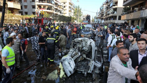 Widespread damage: People gather at the scene of two explosions near the Iranian embassy in Beirut on Tuesday.