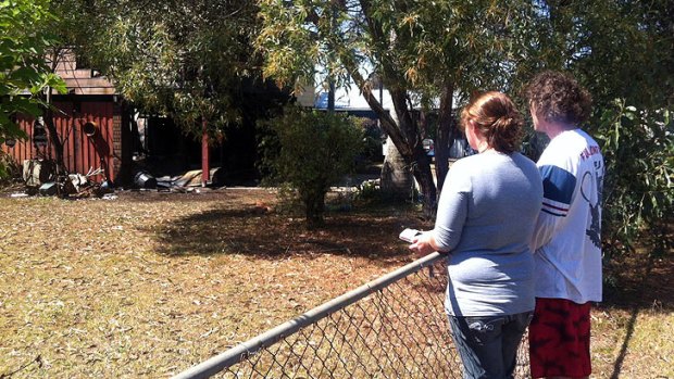 Lyle Shoebridge and his sister survey the aftermath of a fire that nearly claimed a toddler.