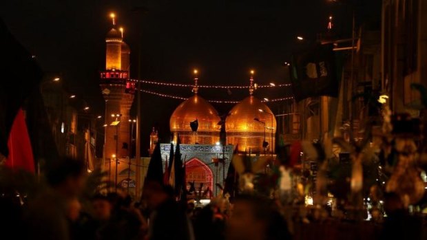 Shiite Muslims gather in the street leading towards the twin shrines of Imam Musa al-Kadhim and Imam Muhammad al-Taqi.