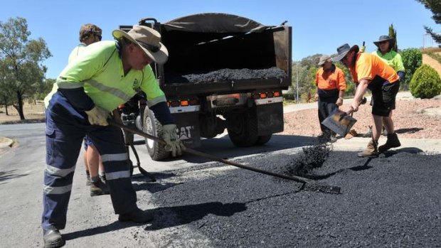 The ACT Government Road Maintainence Team lays bitumen in Carr Crescent, Wanniassa.
